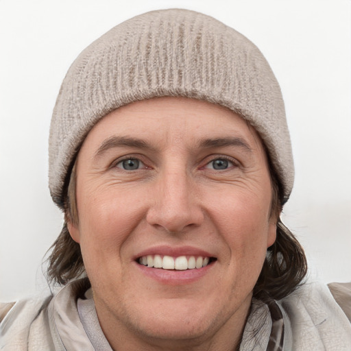 Joyful white adult female with medium  brown hair and blue eyes