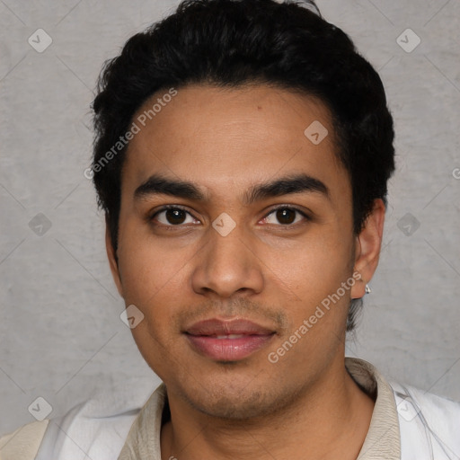 Joyful latino young-adult male with short  black hair and brown eyes