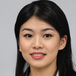 Joyful asian young-adult female with long  black hair and brown eyes