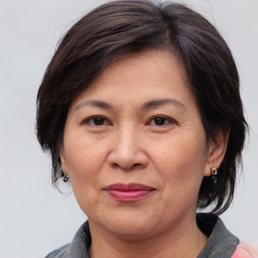 Joyful white adult female with medium  brown hair and brown eyes