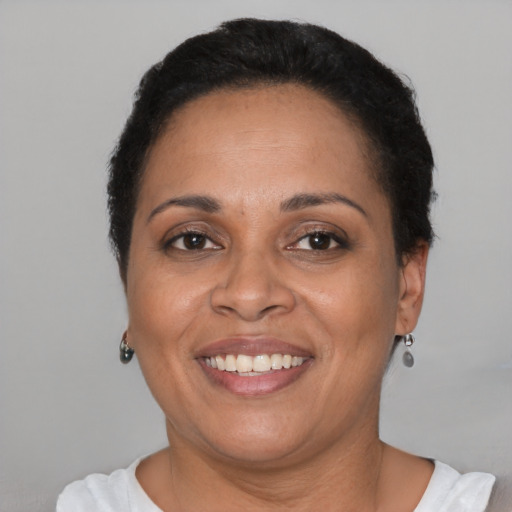 Joyful latino adult female with short  brown hair and brown eyes