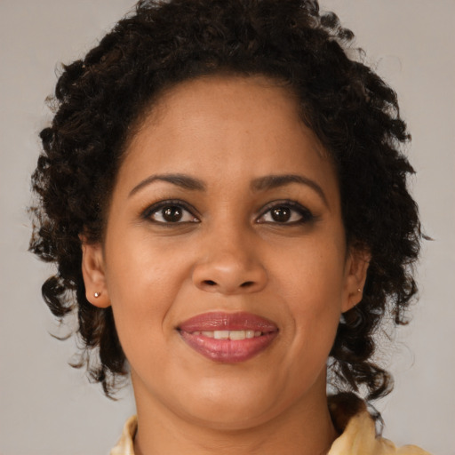 Joyful black young-adult female with medium  brown hair and brown eyes