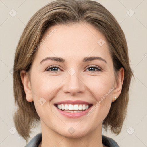 Joyful white young-adult female with medium  brown hair and grey eyes