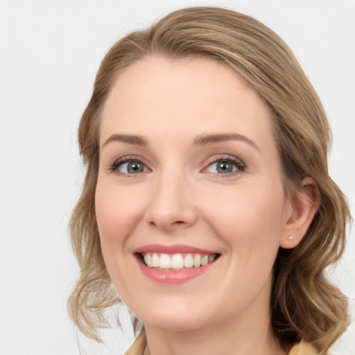 Joyful white young-adult female with medium  brown hair and blue eyes