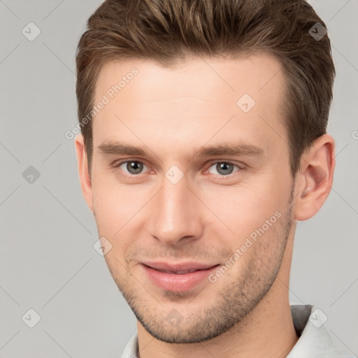 Joyful white young-adult male with short  brown hair and brown eyes