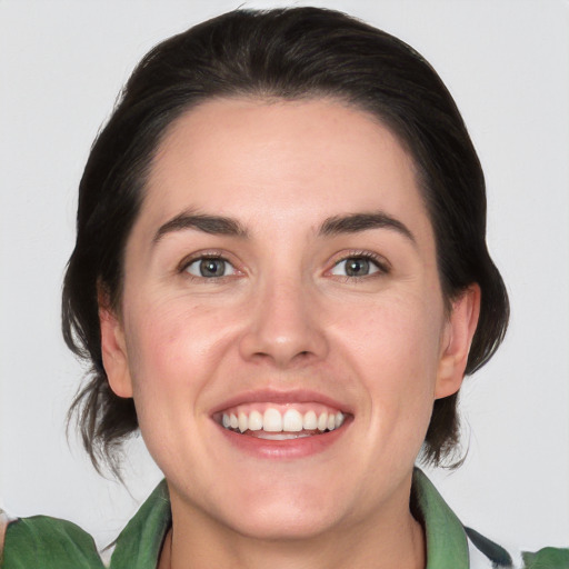 Joyful white young-adult female with medium  brown hair and green eyes