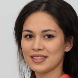 Joyful asian young-adult female with long  brown hair and brown eyes