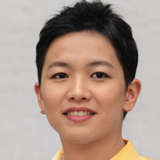 Joyful asian young-adult female with short  brown hair and brown eyes