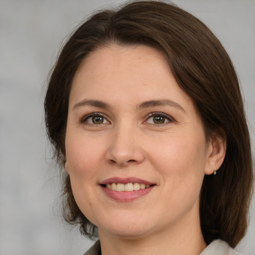 Joyful white young-adult female with medium  brown hair and brown eyes