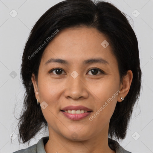 Joyful latino young-adult female with medium  brown hair and brown eyes