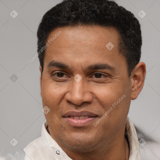 Joyful latino adult male with short  brown hair and brown eyes