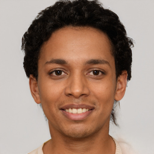 Joyful latino young-adult male with short  black hair and brown eyes