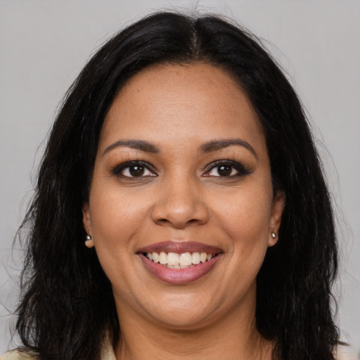 Joyful latino young-adult female with long  black hair and brown eyes