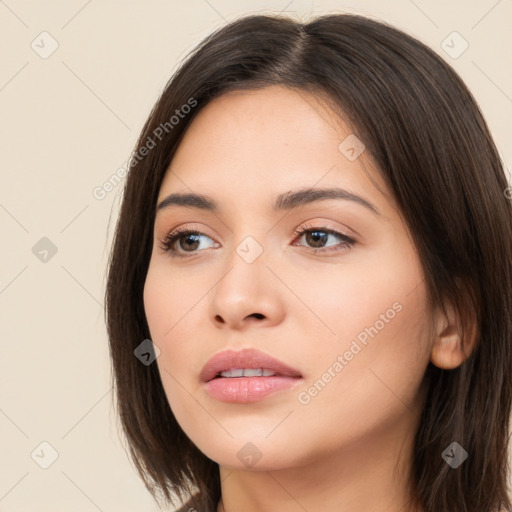 Neutral white young-adult female with long  brown hair and brown eyes