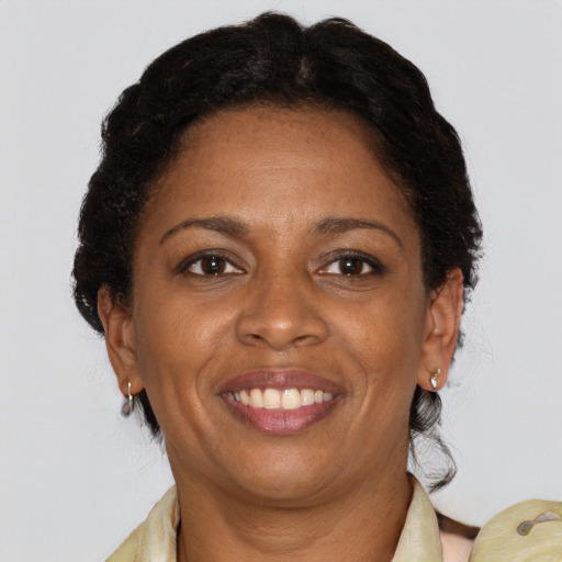 Joyful black adult female with medium  brown hair and brown eyes