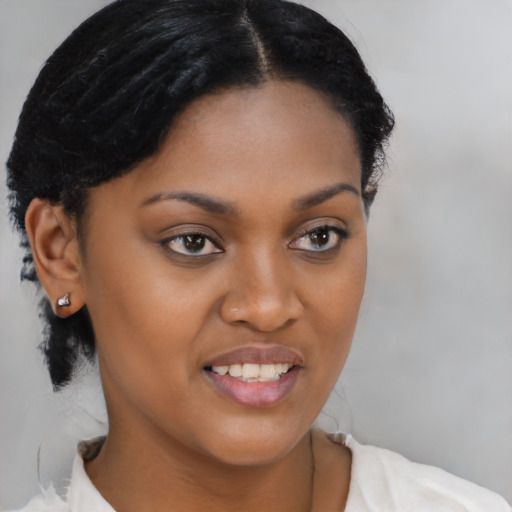 Joyful black young-adult female with short  brown hair and brown eyes