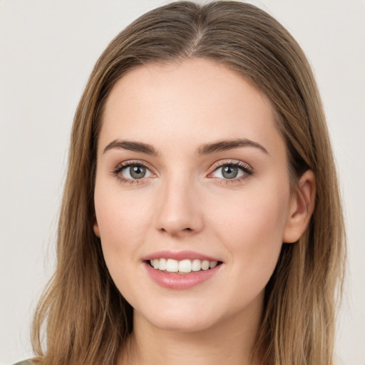 Joyful white young-adult female with long  brown hair and green eyes