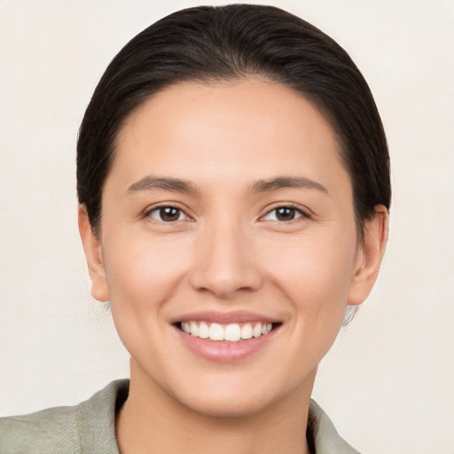 Joyful white young-adult female with medium  brown hair and brown eyes