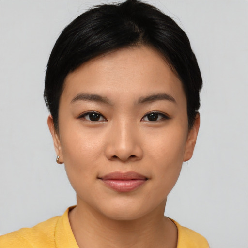 Joyful asian young-adult female with short  black hair and brown eyes