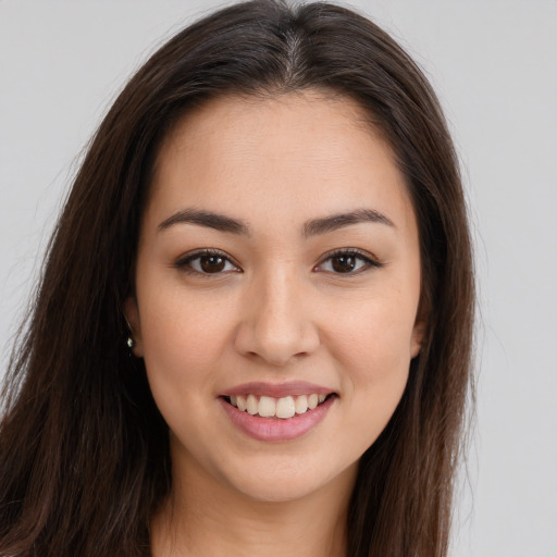 Joyful white young-adult female with long  brown hair and brown eyes