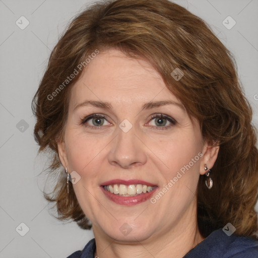 Joyful white adult female with medium  brown hair and blue eyes