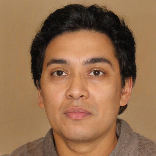 Neutral latino adult male with short  black hair and brown eyes