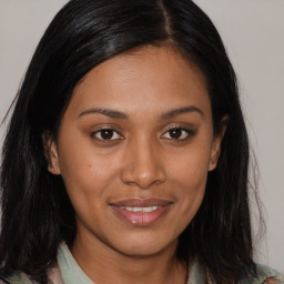 Joyful asian young-adult female with long  brown hair and brown eyes