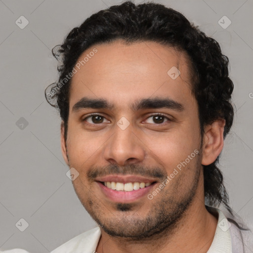 Joyful latino young-adult male with short  black hair and brown eyes