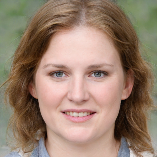 Joyful white young-adult female with medium  brown hair and blue eyes