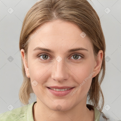 Joyful white young-adult female with medium  brown hair and grey eyes