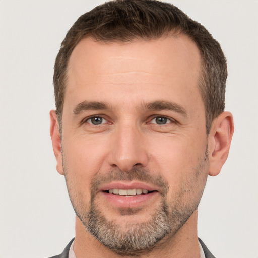 Joyful white adult male with short  brown hair and brown eyes