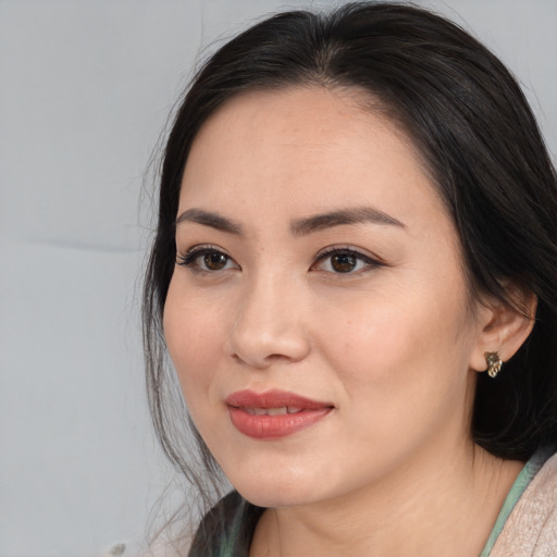 Joyful asian young-adult female with long  black hair and brown eyes