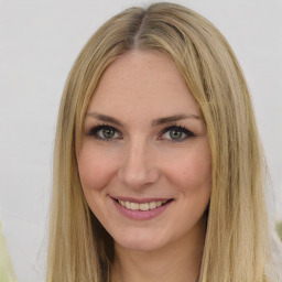 Joyful white young-adult female with long  brown hair and green eyes