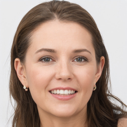 Joyful white young-adult female with long  brown hair and grey eyes