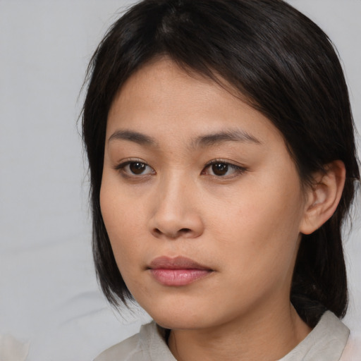 Neutral asian young-adult female with medium  brown hair and brown eyes