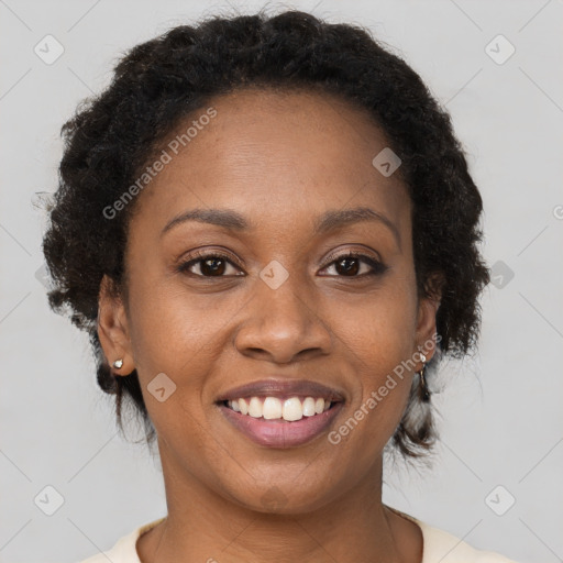 Joyful black young-adult female with short  brown hair and brown eyes