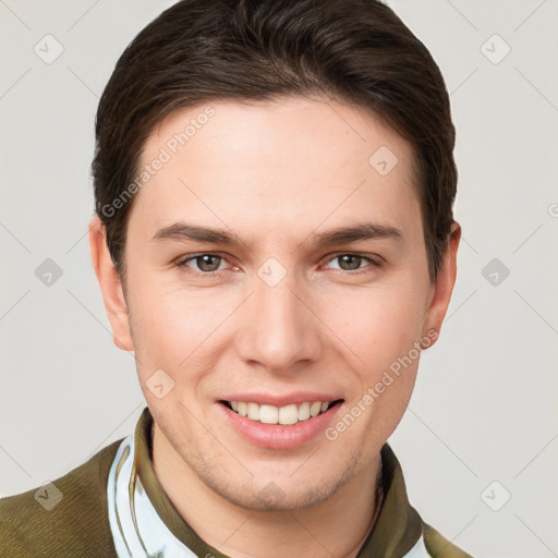 Joyful white young-adult male with short  brown hair and grey eyes