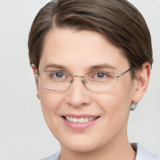 Joyful white young-adult female with short  brown hair and grey eyes