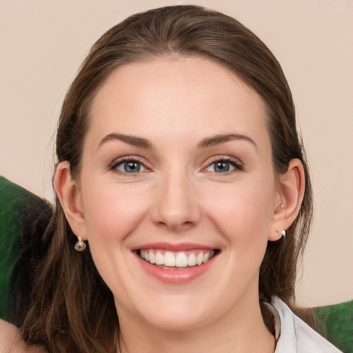 Joyful white young-adult female with medium  brown hair and grey eyes