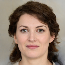 Joyful white young-adult female with medium  brown hair and green eyes