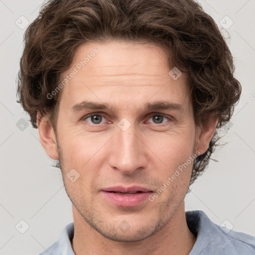 Joyful white adult male with short  brown hair and grey eyes