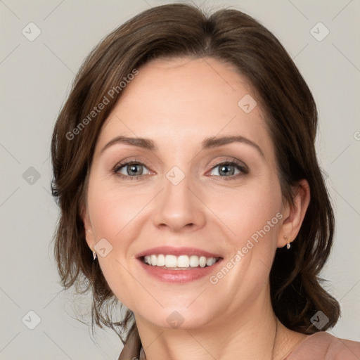 Joyful white young-adult female with medium  brown hair and grey eyes