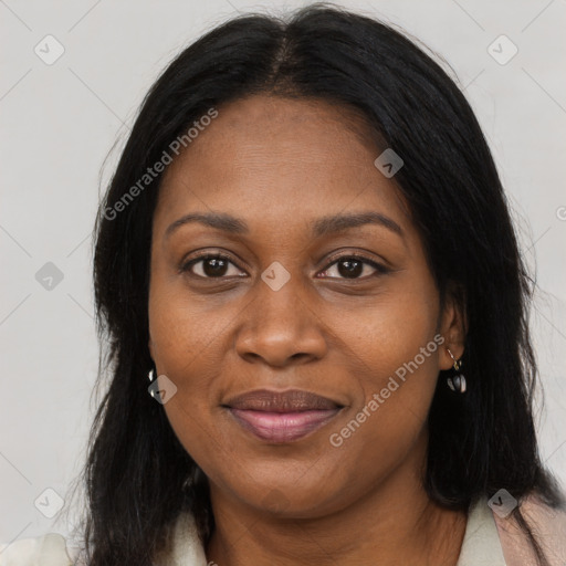 Joyful black young-adult female with long  brown hair and brown eyes