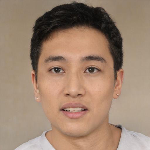 Joyful white young-adult male with short  black hair and brown eyes