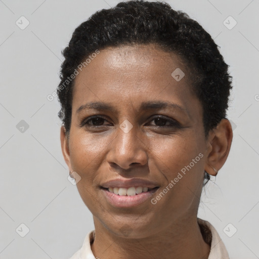 Joyful black adult female with short  brown hair and brown eyes