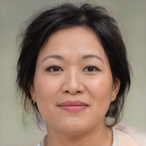 Joyful asian adult female with medium  brown hair and brown eyes