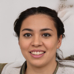 Joyful latino young-adult female with medium  brown hair and brown eyes