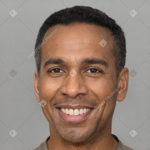 Joyful latino adult male with short  black hair and brown eyes