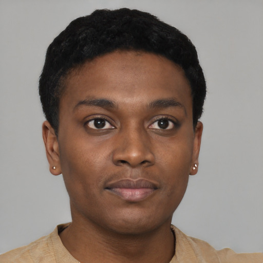 Joyful black young-adult male with short  black hair and brown eyes