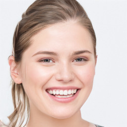 Joyful white young-adult female with long  brown hair and blue eyes